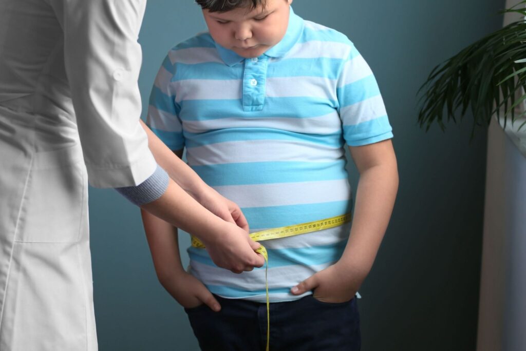Doctor Measuring Boys Waist